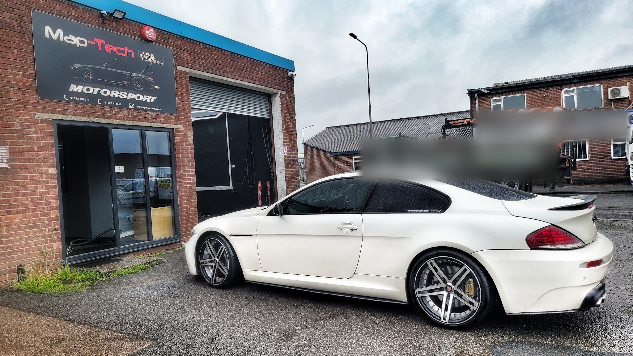 A white BMW 6 Series on the forecourt outside the Map-Tech Motorsport unit on Island Carr Rd, Brigg